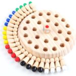 A wooden board with colored pins ({{Montessori pawn game}}).