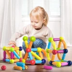 A little girl explores the blocks of the Magnetic Construction Game for Children.