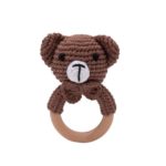 A wooden hocet with knitted animals on a wooden ring.
