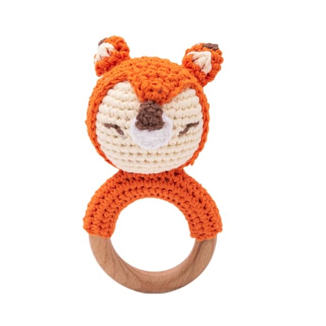 A crocheted fox ring with knitted wooden animal rattles.