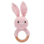 A knitted rabbit wooden rattle with a crocheted rabbit ring.
