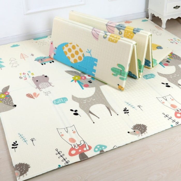 A baby's room with a Foldable Animal Floor Mat featuring cute animal motifs.
