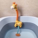 A Giraffe toy sits in a bathtub, Water Jet Sprinkler - Giraffe.