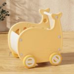 A yellow giraffe toy Chariot Marche Bébé - Whale on a wooden table.