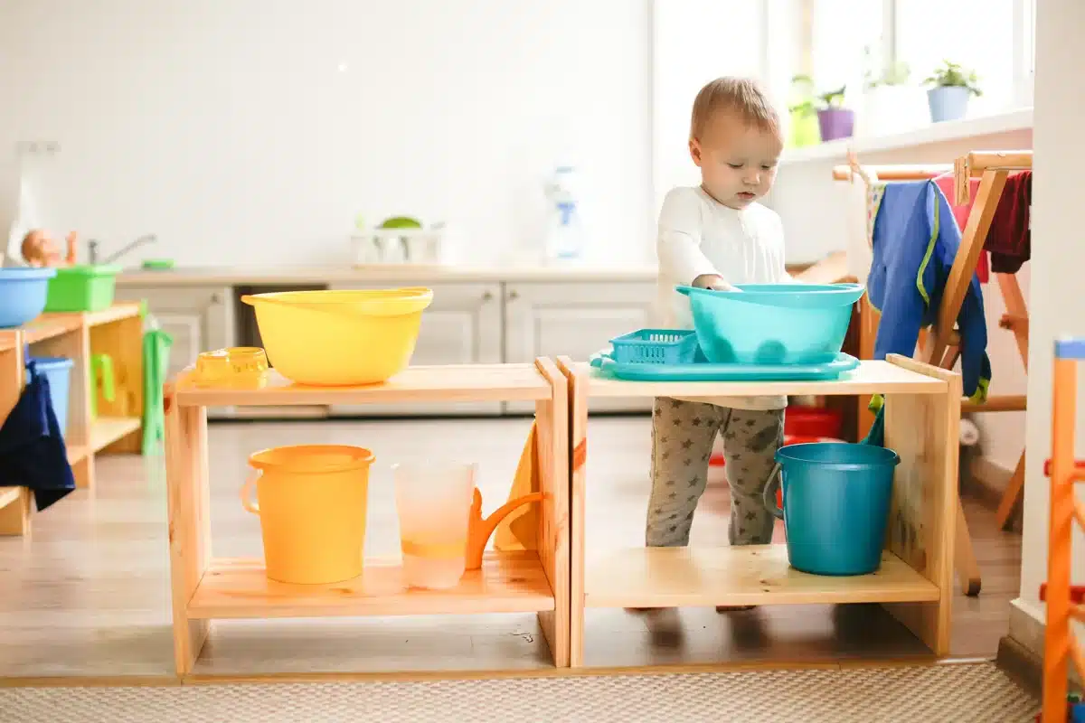 A child plays with Montessori games in a playroom to develop independence.