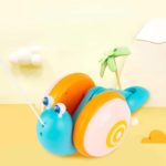 A Pulling Game - Musical Snail is sitting on a sandy beach.