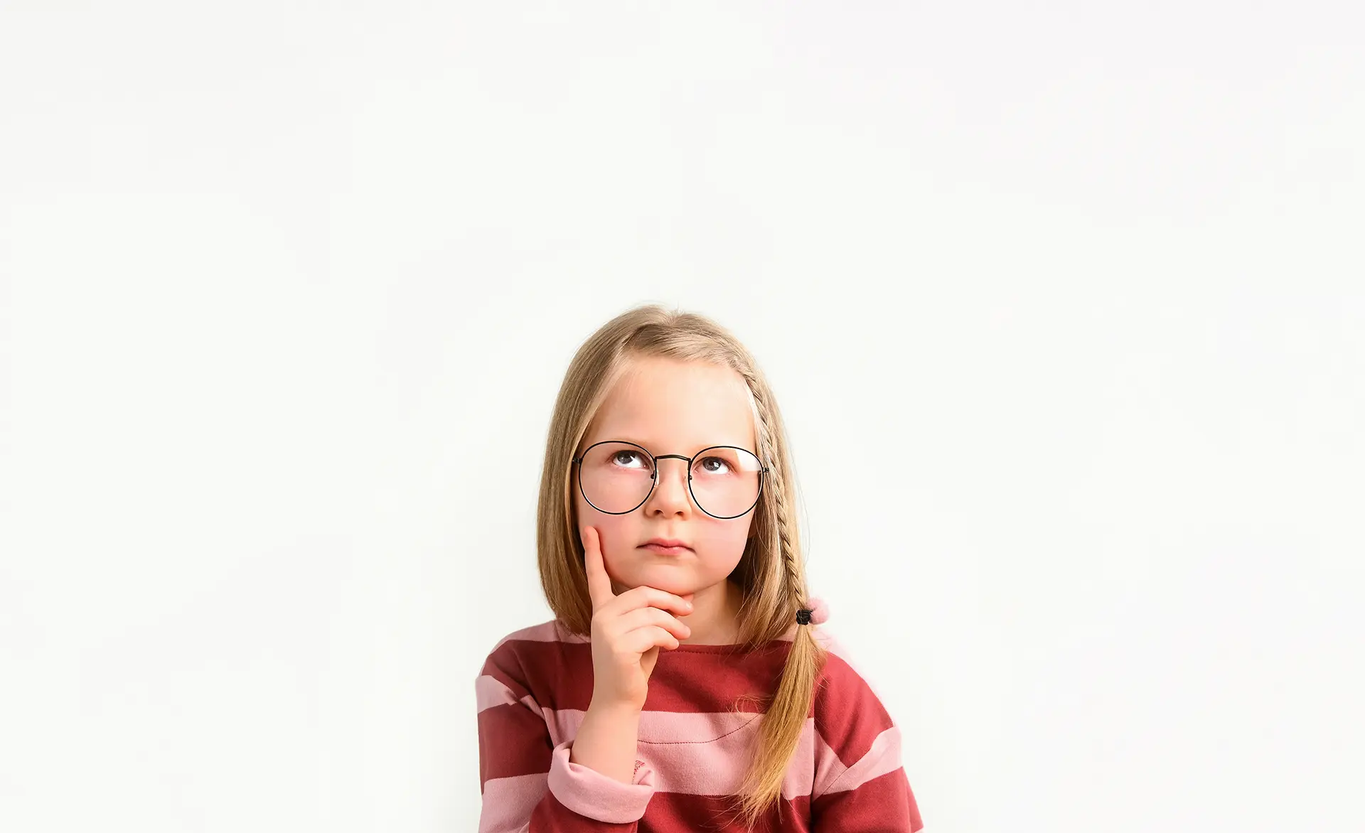 A little girl with glasses on her face.