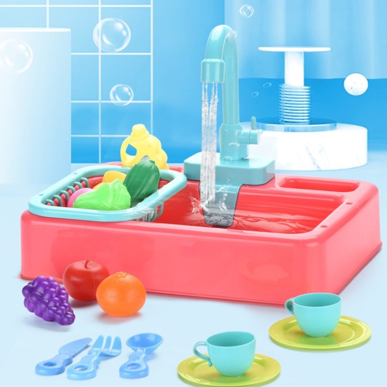 A toy kitchen sink with fruit and utensils.