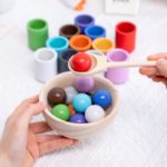 One person holding a Montessori Wooden Toy Sorting Ball and Cup.