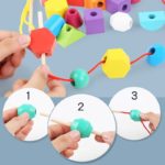 Someone demonstrates how to make a wooden bead toy using the Shape Matching Game.