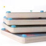 A stack of wooden puzzles, including a Magnetic Wooden Labyrinth - Montessori Puzzle, designed in the Montessori style.