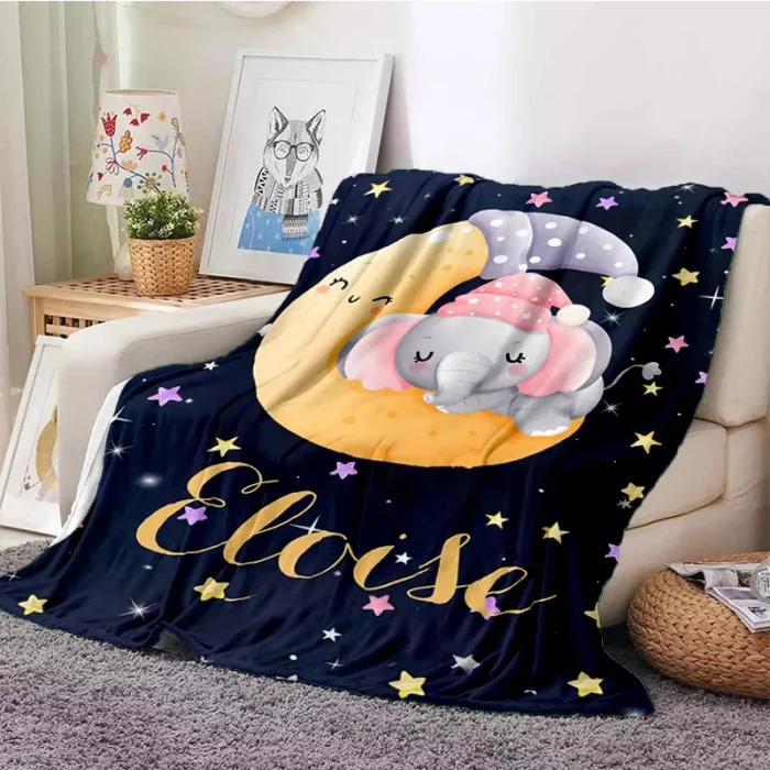 A blanket with an elephant on the moon and stars.