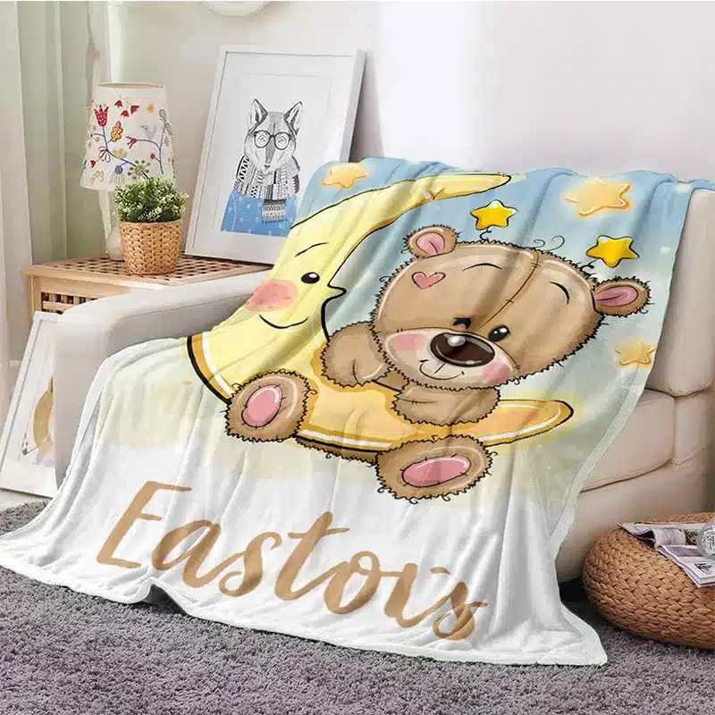 A blanket in the shape of a teddy bear with the word Easter on it.