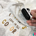 One person holds a First Name Clothing Stamp - Fast and resistant to +1000 washes that says friends come in all colors.