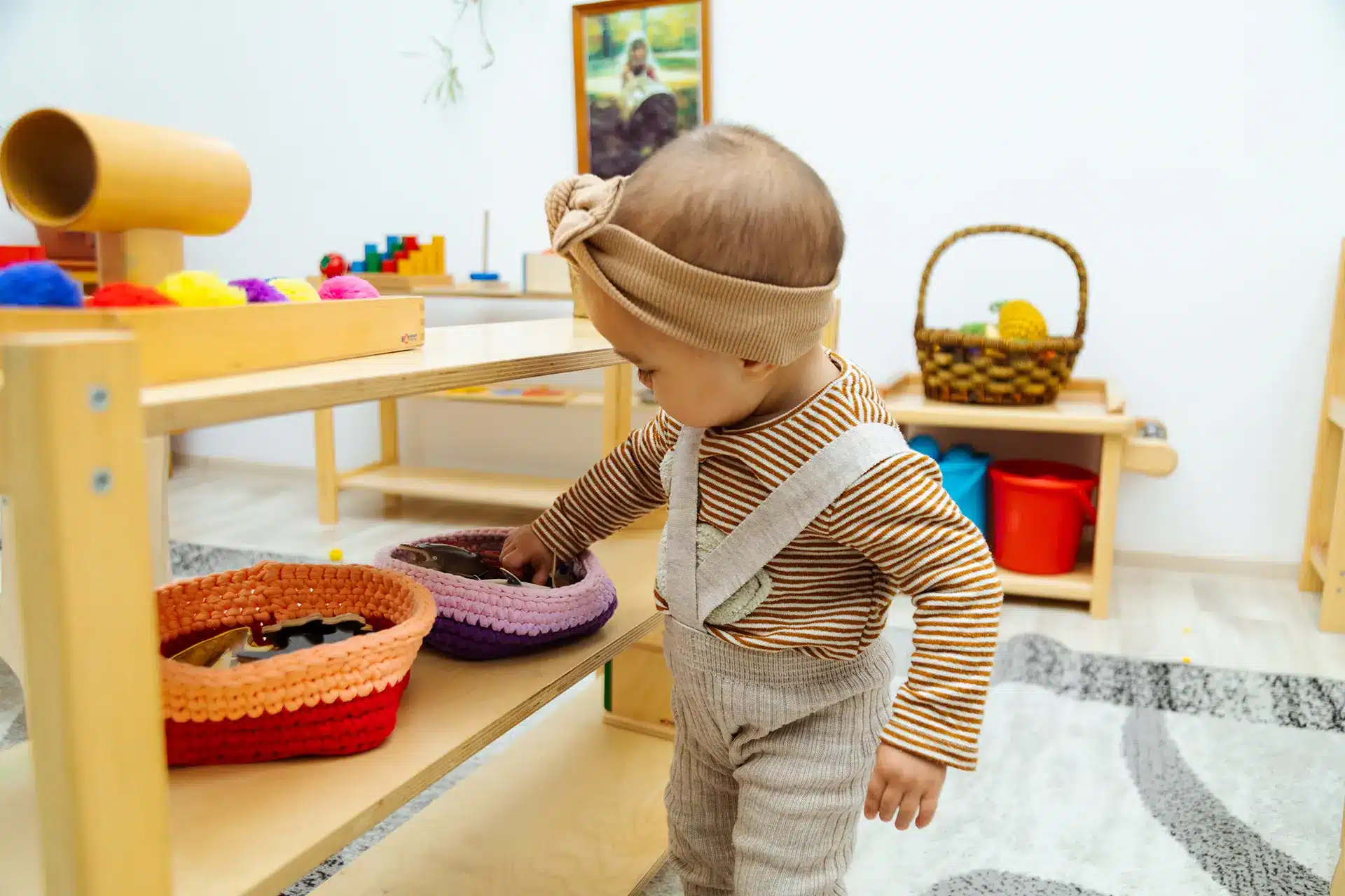 A child plays with educational wooden toys in a playroom.