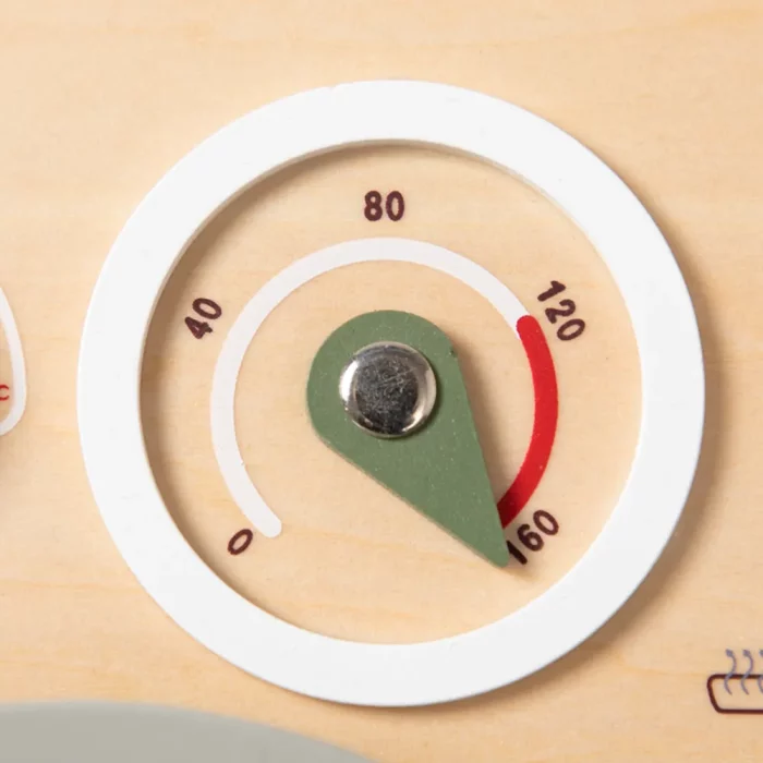 A close-up of a thermometer on a wooden surface.