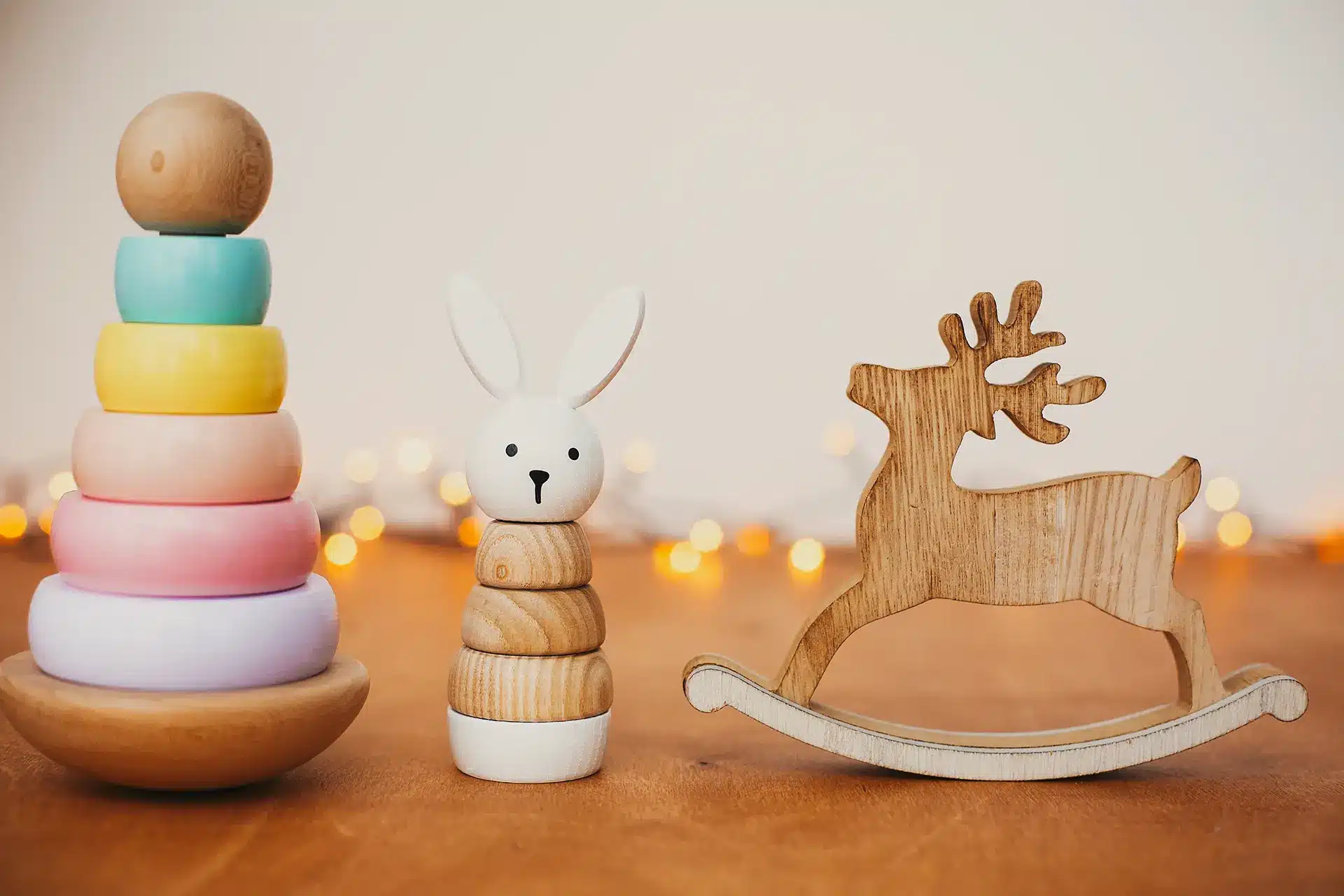 Montessori wooden toys for every age: a playful, caring approach with a rabbit and a reindeer.
