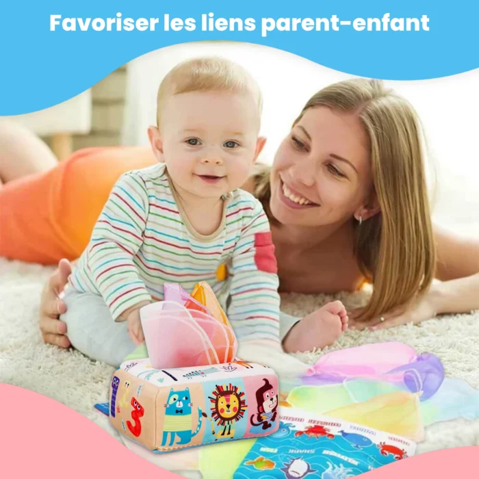 Une femme souriante et un bébé jouent par terre avec des mouchoirs en tissu colorés de la Boîte à Mouchoirs Magique et une boîte à jouets. Au-dessus d'eux, on peut lire : "Favoriser les liens parent-enfant.